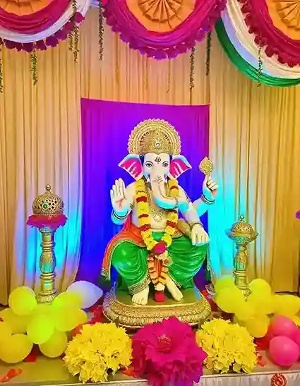 Vibrant Ganesh Chaturthi floral decoration with colorful backdrop and traditional elements | Traditional Ganesh Chaturthi Floral Decor | Festival Decorations | Decorations Guru